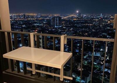 High-rise apartment balcony with cityscape view at night