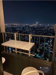 High-rise apartment balcony with cityscape view at night