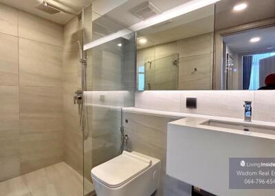 Modern bathroom with glass shower enclosure and sleek vanity