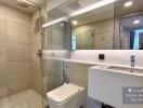 Modern bathroom with glass shower enclosure and sleek vanity