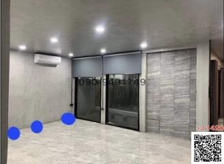 Modern spacious building interior with large glass doors and recessed lighting
