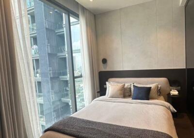 Modern bedroom with city view through large window