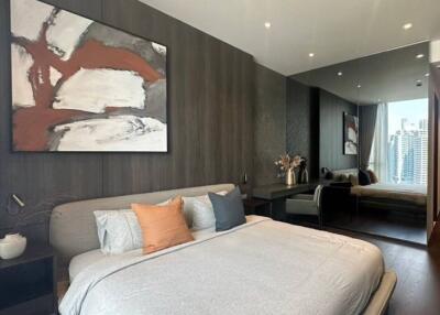 Modern bedroom with a double bed and artistic wall decor in a high-rise apartment