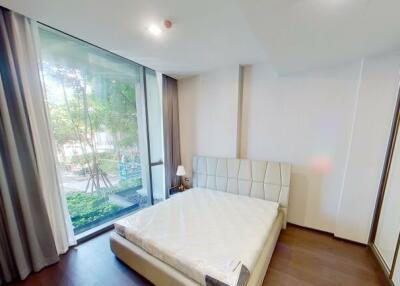 Modern bedroom interior with large window and outdoor view