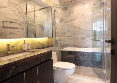 Modern bathroom with marble tiles and glass shower