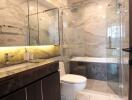 Modern bathroom with marble tiles and glass shower