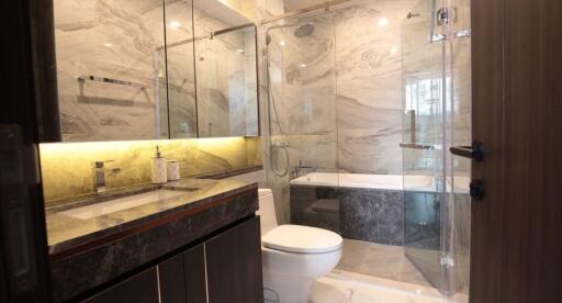 Modern bathroom with marble tiles and glass shower