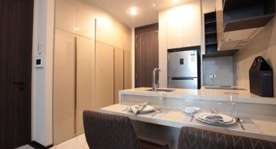 Modern kitchen with integrated appliances and dining area