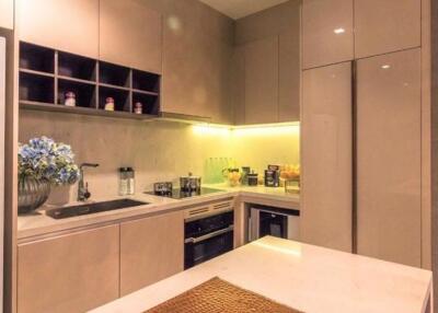 Modern kitchen with integrated appliances and under-cabinet lighting