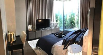 Elegant bedroom with a modern aesthetic, featuring a large window and sophisticated decor