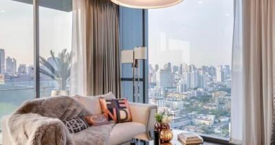 Modern living room with floor-to-ceiling windows offering a city view