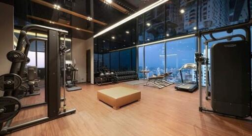 Modern home gym with large windows and city view