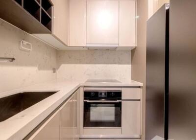 Modern kitchen with built-in appliances and marble countertop