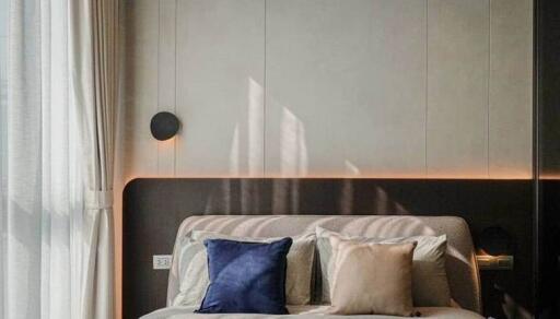 Elegant modern bedroom with neutral tones and stylish lighting