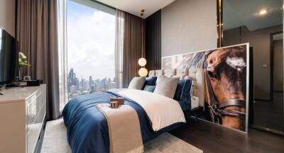 Modern bedroom with a large window overlooking the city