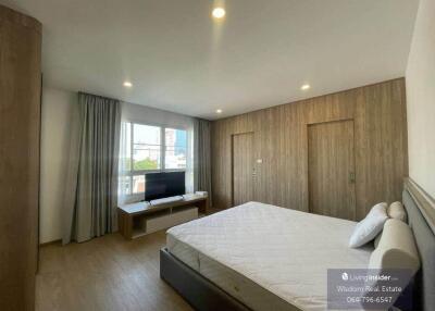 Modern bedroom with large windows and ample lighting