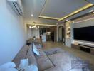 Modern living room interior with open kitchen design, comfortable sofa, and entertainment unit