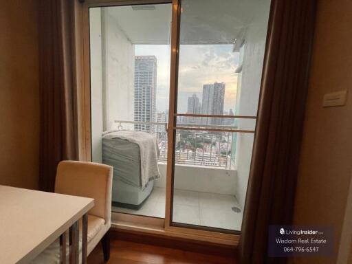Compact bedroom with large window and city view
