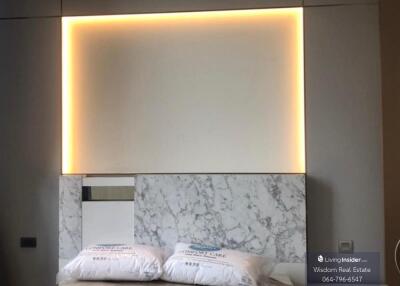 Modern bedroom with ambient lighting and marble headboard