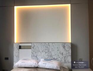 Modern bedroom with ambient lighting and marble headboard