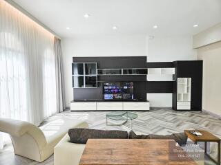 Spacious and modern living room with large entertainment center