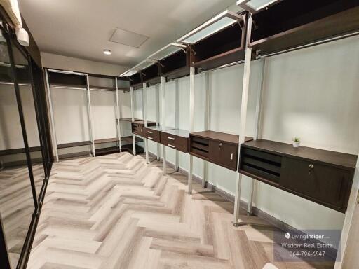 Spacious walk-in closet with custom shelving and modern design