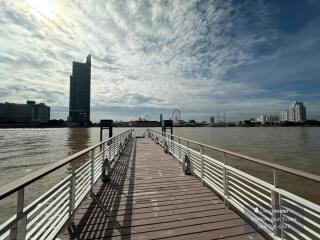 Spacious riverfront deck with a view of the city skyline and ferris wheel