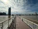 Spacious riverfront deck with a view of the city skyline and ferris wheel