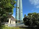 Tall modern residential skyscraper with greenery in the foreground