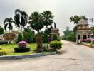 Elegant entrance of a residential community with tropical landscaping