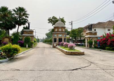 Elegant residential gated community entrance with lush landscaping