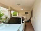 Spacious covered garage with a parked car and storage space