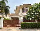 Elegant residential home front view with garden and gated entrance
