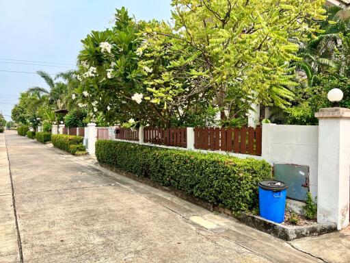 Lush greenery and tidy suburban street with private fencing