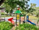 Colorful children's playground in a park with greenery