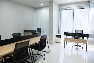 Modern office space with wooden desks and ergonomic chairs