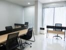 Modern office space with wooden desks and ergonomic chairs
