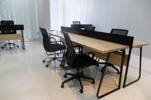 Spacious office room with large wooden table and chairs