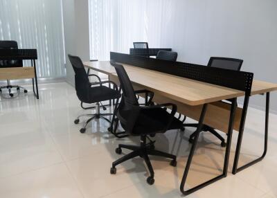 Spacious office room with large wooden table and chairs