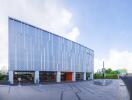 Modern commercial building with distinctive patterned facade and integrated cafe