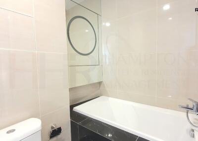 Modern bathroom with reflective surfaces and clean design