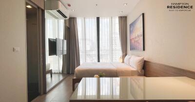 Modern bedroom interior with a comfortable bed, large windows, and elegant decor