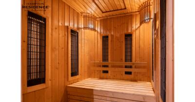 Interior of a spacious wooden sauna with multiple bench seats