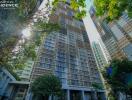 View of modern high-rise residential building, Hampton Residence, amidst green trees