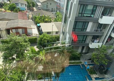 Aerial view of a modern residential complex with pool and lush greenery