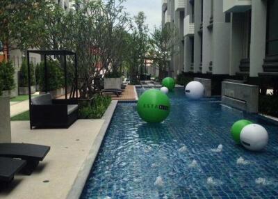 Luxurious outdoor swimming pool area with residential buildings