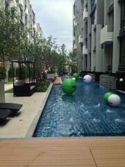 Luxurious outdoor swimming pool area with residential buildings