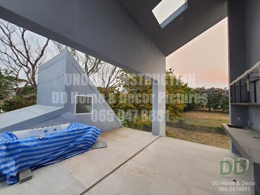 Spacious patio with partial covering and garden view