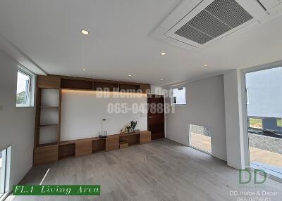 Modern living area with wooden shelves and recessed lighting