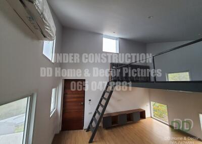 Spacious under construction living area with high ceiling and mezzanine